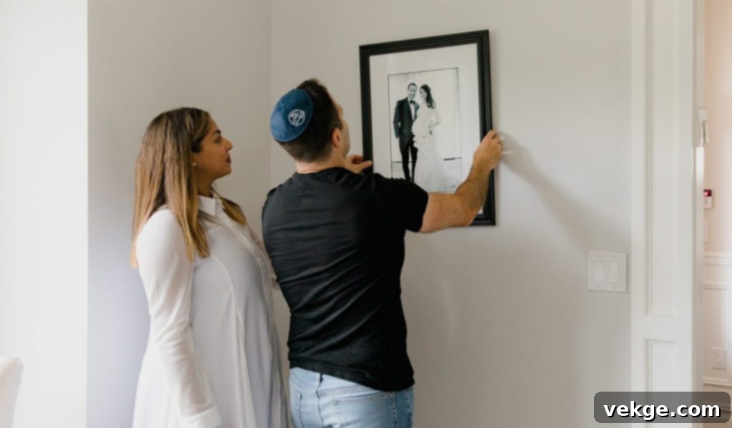Use Photos to Tell a Story: A collection of framed family photos arranged chronologically on a light-colored wall, creating a visual narrative.