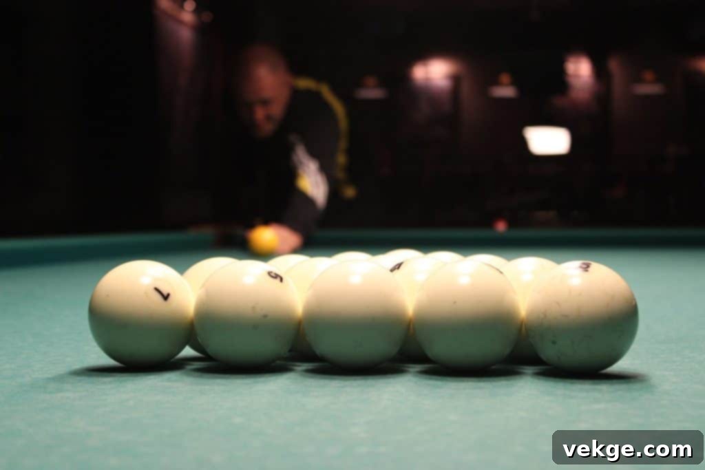 A vibrant home entertainment area with a pool table, comfortable seating, and a large screen for gaming or movies, showcasing diverse entertainment options.