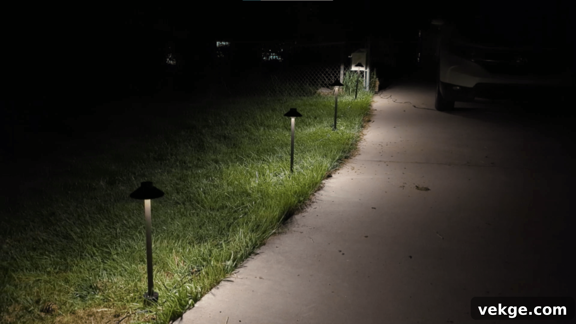 Well-lit garden path at dusk, featuring low-voltage path lights for safety and ambiance.