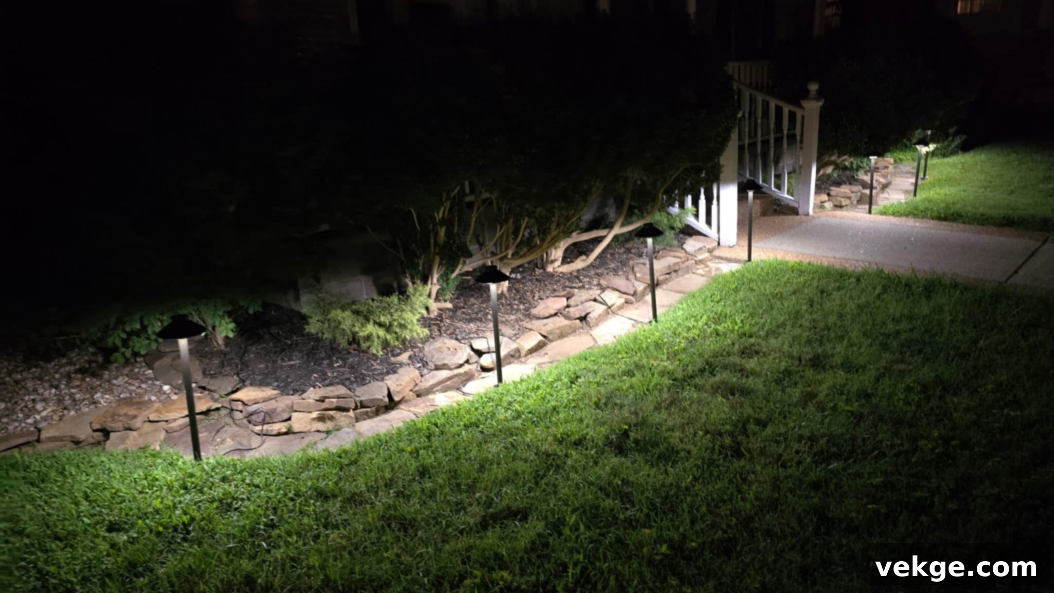 Beautifully illuminated outdoor path in a modern garden, highlighting architectural and landscape features.