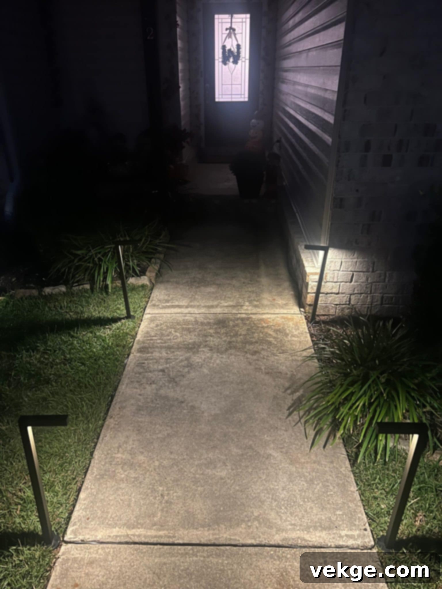 Illustration demonstrating the beam spread and coverage of pathway lights on a walkway.