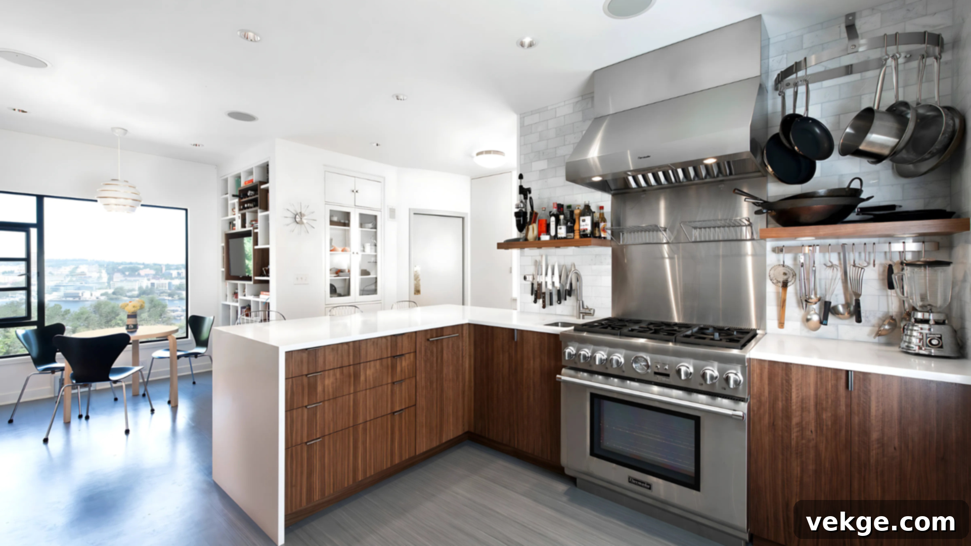 A modern kitchen cooking zone with a stovetop and oven, pots, and pans neatly arranged