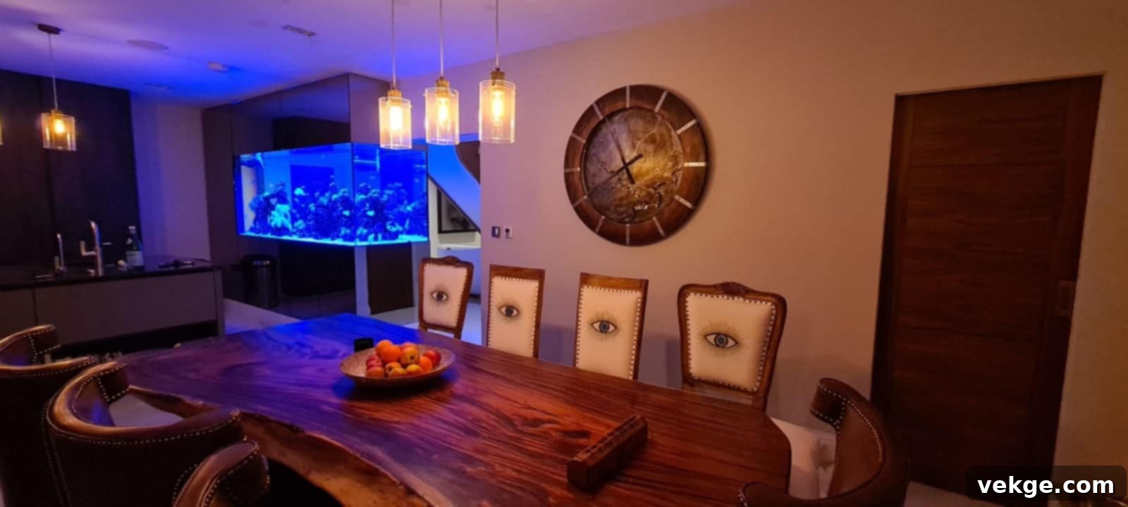 A modern dining room featuring a large, industrial-style wall clock as a central focal point above a wooden dining table, surrounded by minimalist chairs.
