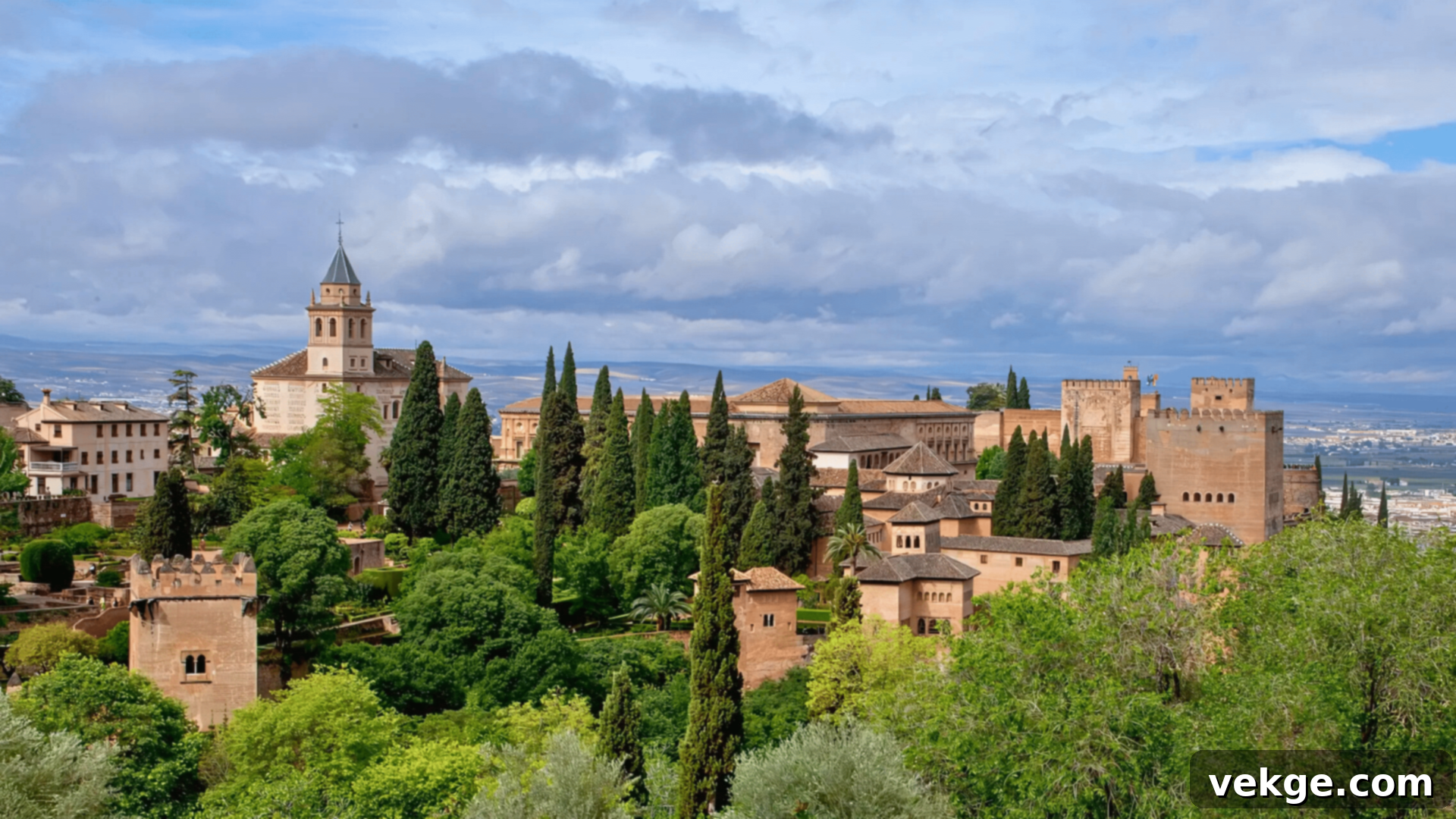 Alhambra Palace and Fortress in Granada, Spain, showcasing intricate Moorish architecture with repeating geometric patterns and stunning courtyards.