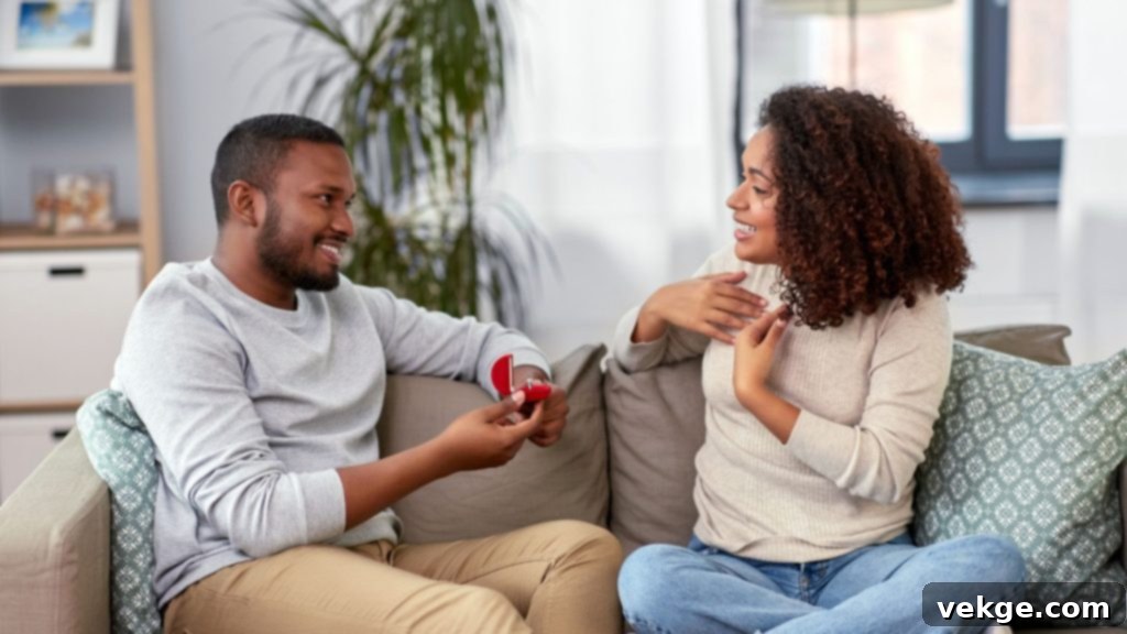 Couple celebrating an at-home proposal with a ring and drinks