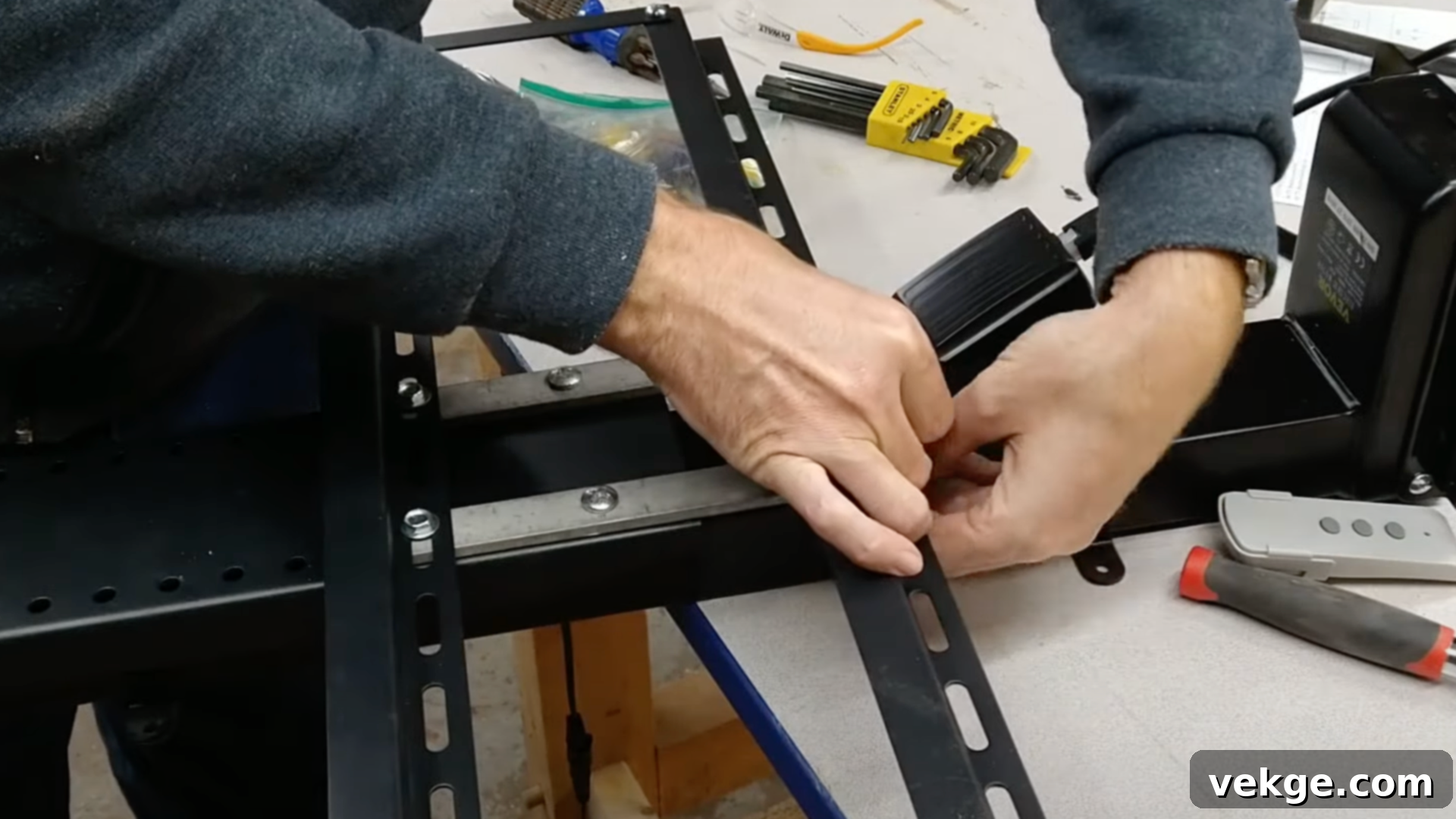Assembling the wooden frame for a TV lift cabinet with screws
