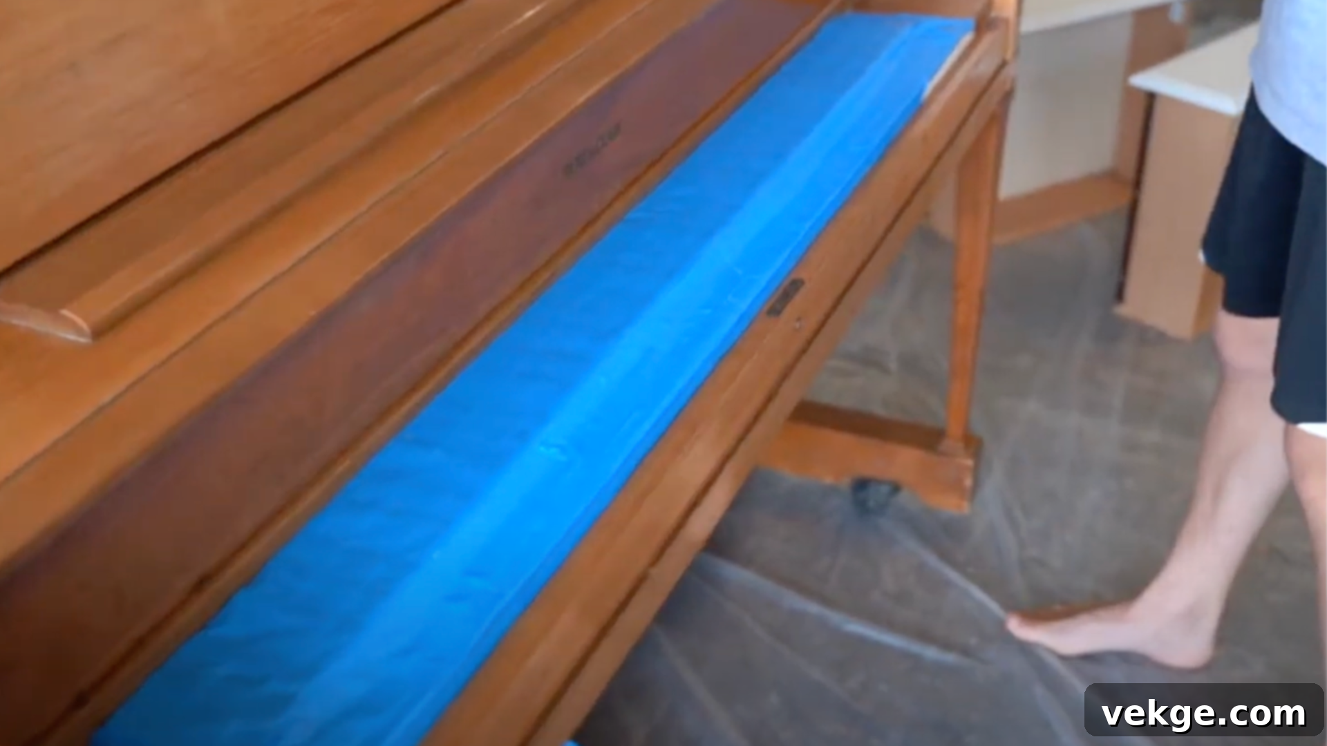 Carefully mask off all piano keys, pedals, and other parts not to be painted using painter's tape and paper.