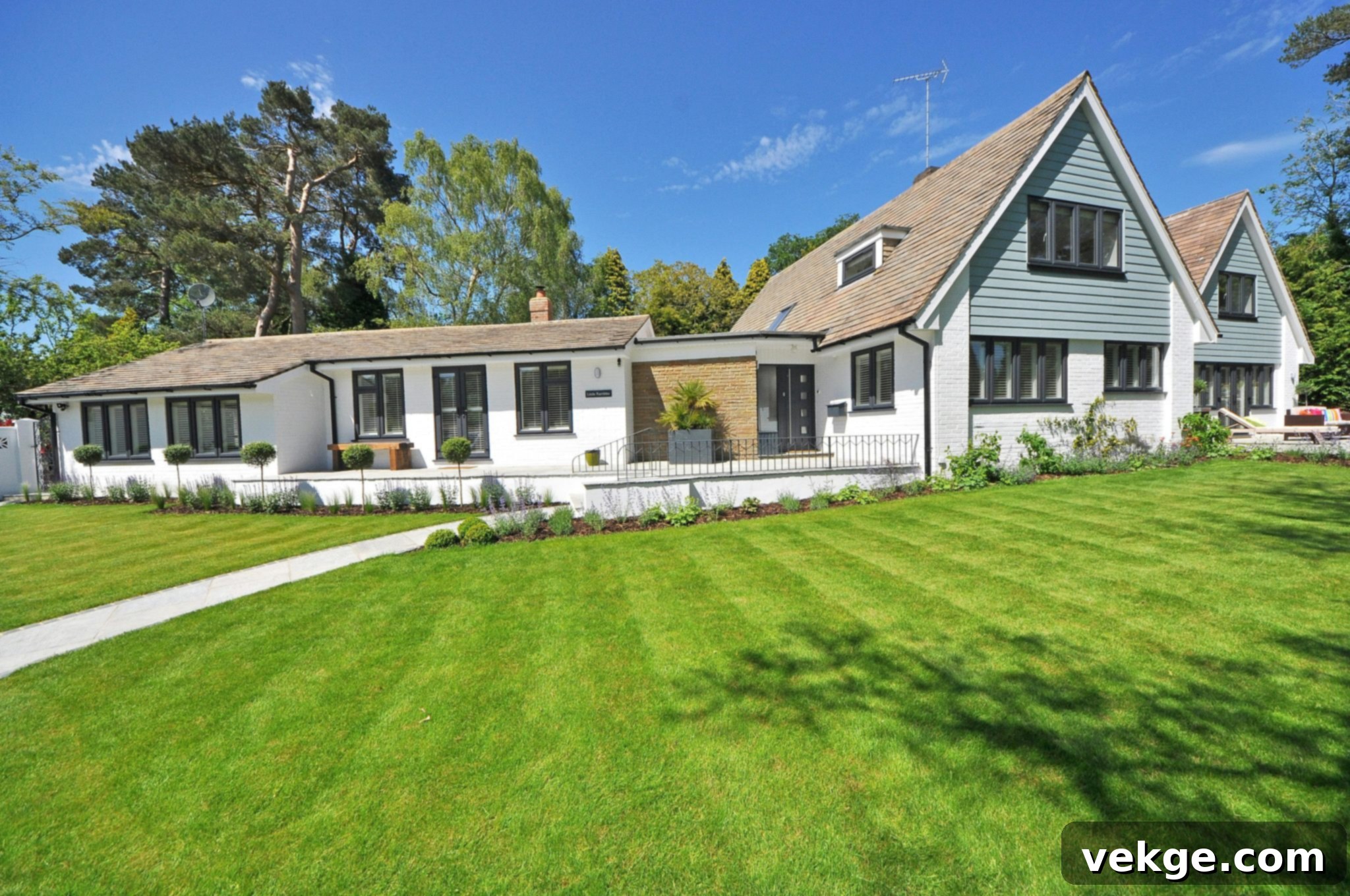Lush green lawn with a house in the background, showcasing well-maintained landscaping