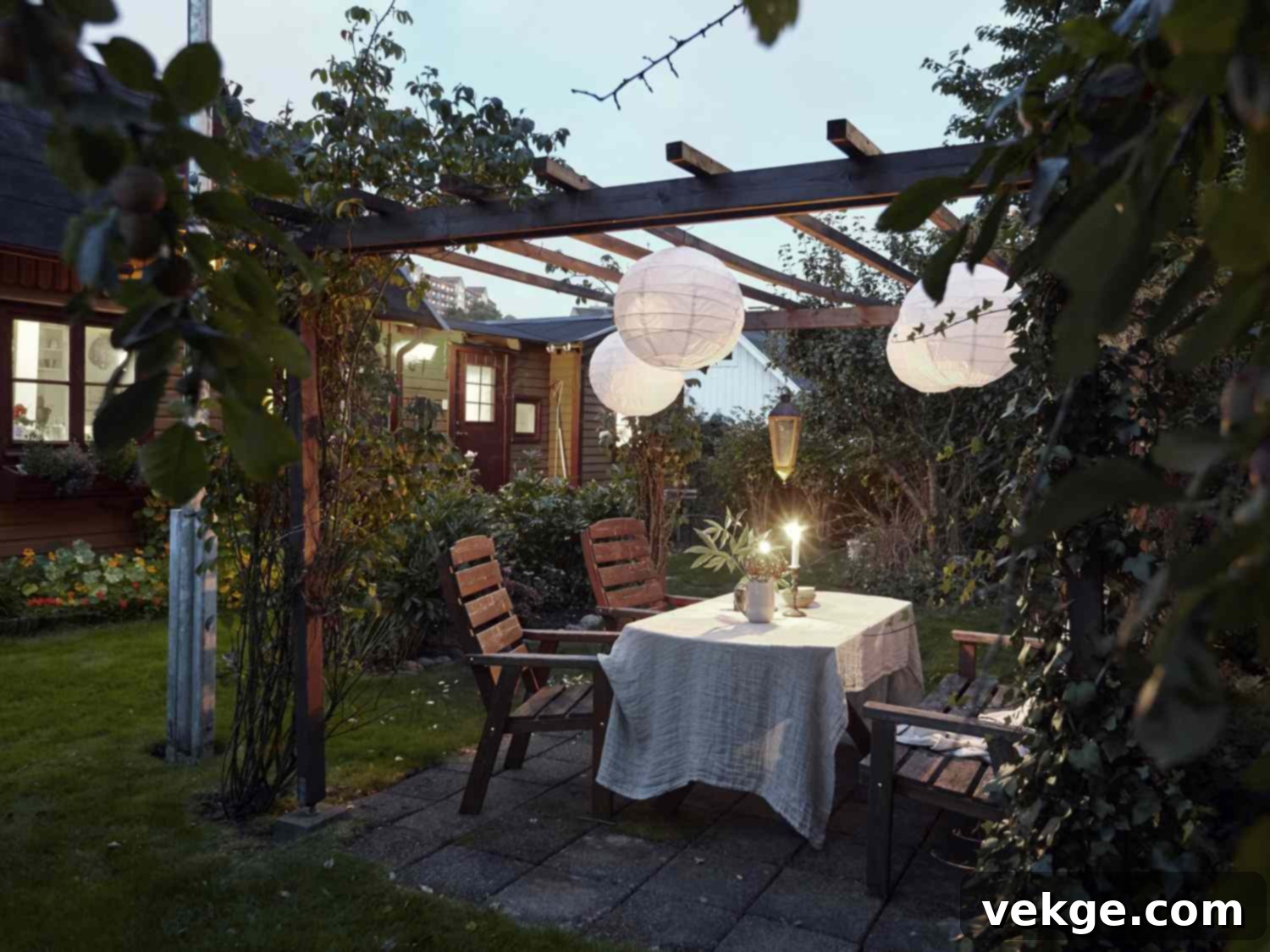 Outdoor pergola with comfortable seating and string lights, demarcating a lounging area