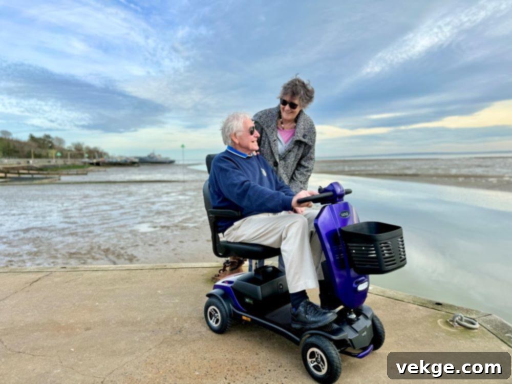 A person confidently riding a mobility scooter outdoors on a paved path