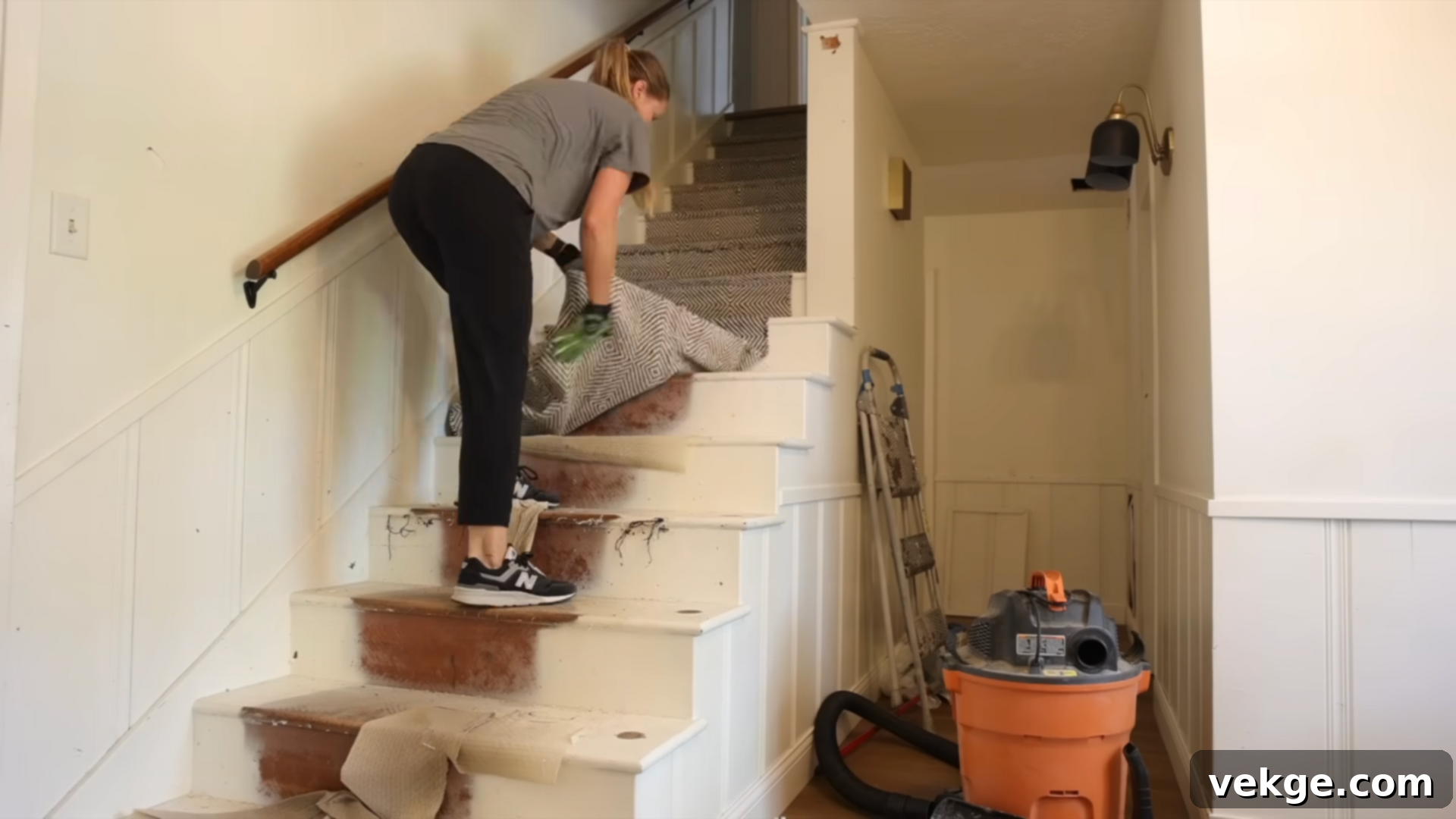 Removing old stair railing and dirty stair runner during renovation