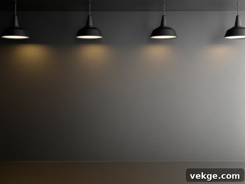 Black pendant lights hanging above a matte black wall with soft illumination
