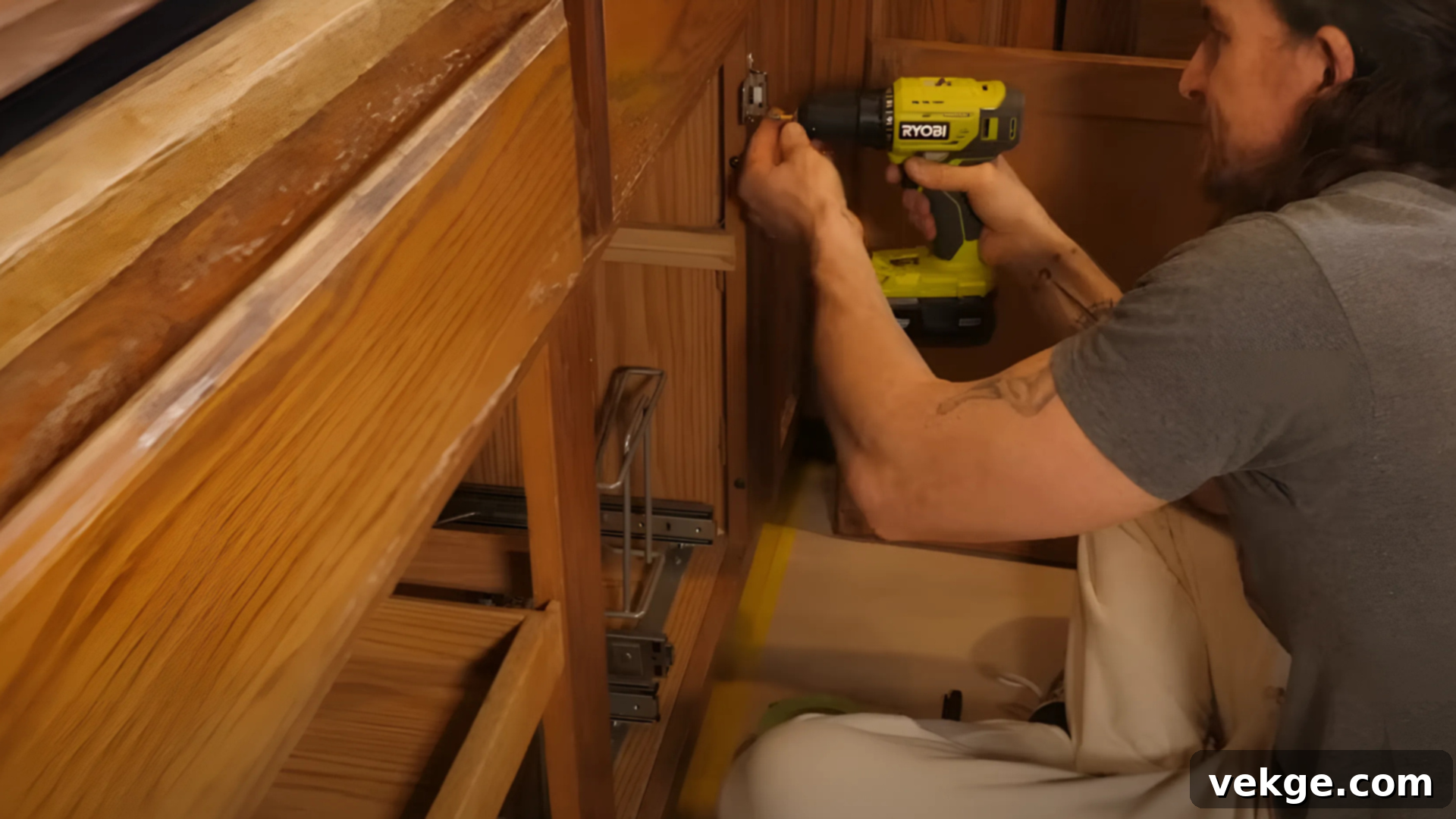 Removing old cabinet hardware with a screwdriver, preparing for a modern update