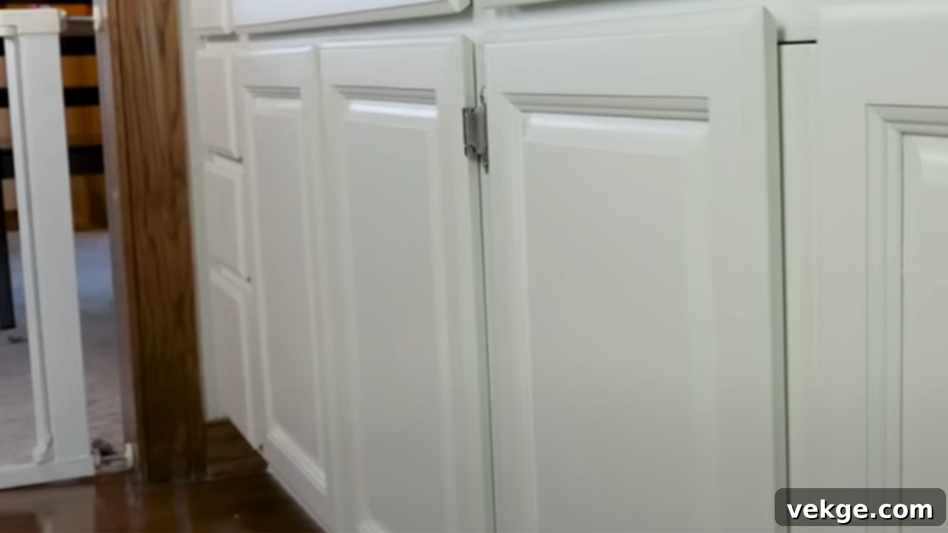 A person meticulously inspecting a newly painted cabinet for imperfections during the final touches