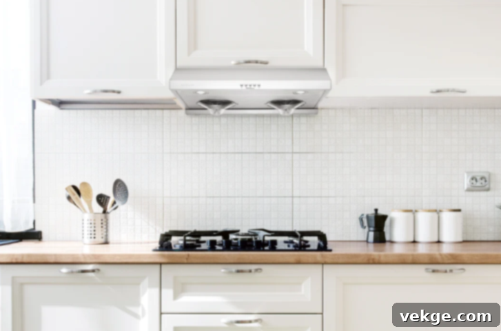 Hauslane UC-100 under-cabinet range hood in a compact kitchen setting, showing its sleek and efficient design.