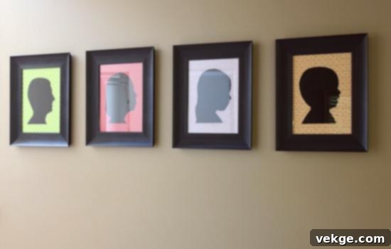 Negative space silhouettes in oval frames on a gallery wall