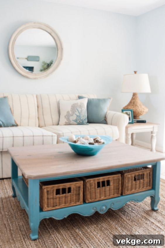 Coastal living room with a turquoise coffee table, striped sofas, and wicker baskets