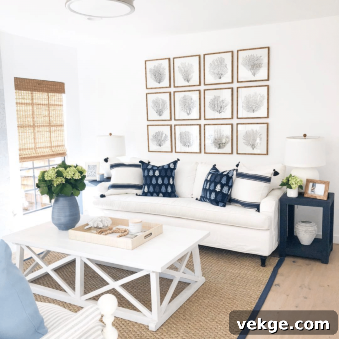 Coastal living room with a white sofa, solid white coffee table, and navy accents