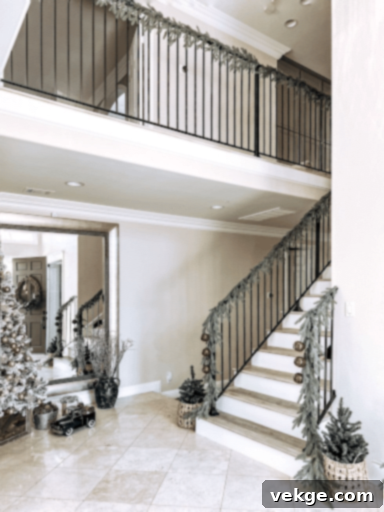 Christmas staircase decorated with garland and jingle bells