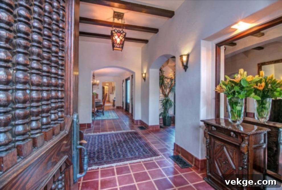 A Southwestern themed entryway featuring rustic wooden furniture, a large circular mirror with a patterned frame, and decorative accents, creating a warm and inviting first impression.