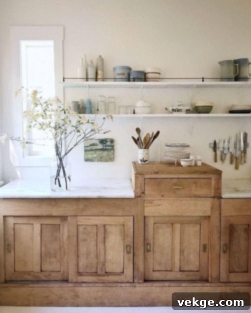 natural wood cabinets: A modern Bohemian kitchen featuring natural wood cabinets paired with a cream backsplash.