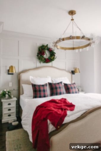 Christmas bedroom with festive wreaths, pillows, and throw blankets