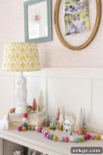 Kids' Christmas bedroom with colorful pompoms and tiny trees