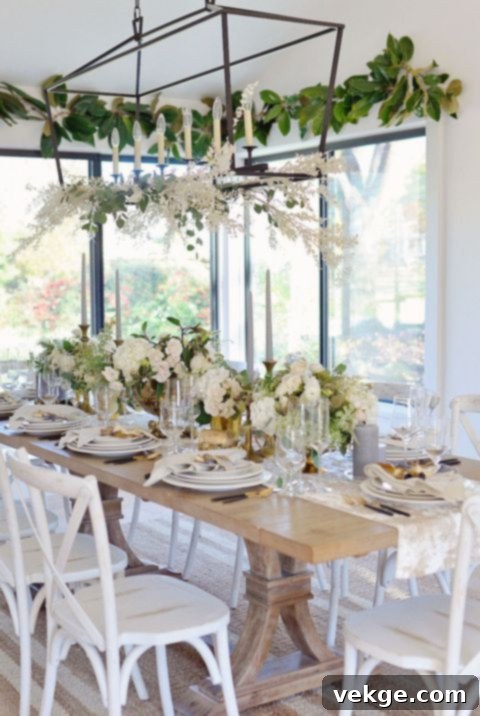 Living room with white furniture and a refreshing touch of green plants, complementing the winter wonderland decor