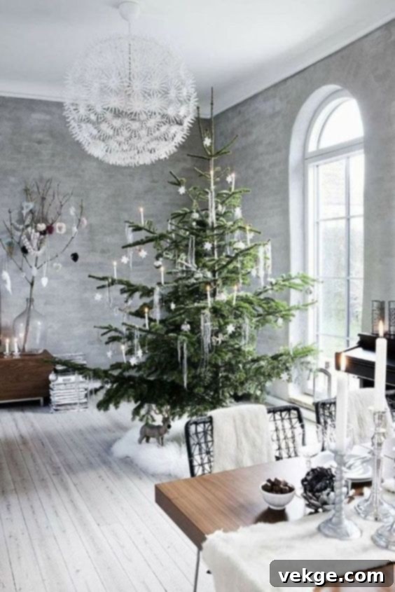 White fur tree skirt, table runner, and chair throws create a cozy white winter aesthetic in a living room