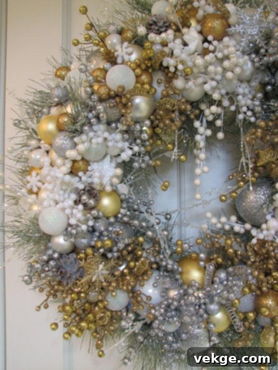 Christmas wreath with gold accents and white elements, showcasing an opulent white and gold decor theme