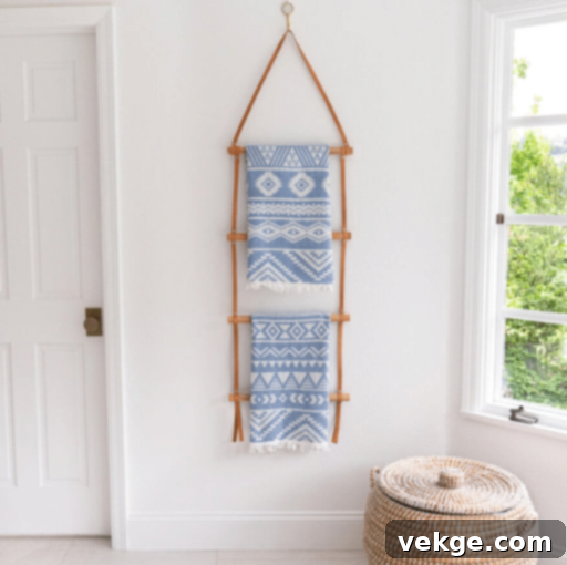 Boho bathroom with a leather-strapped wall-hanging blanket ladder for storage and decor