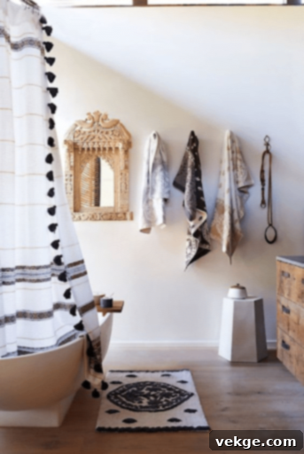 Neutral bohemian bathroom highlighting printed towels and ornate mirrors