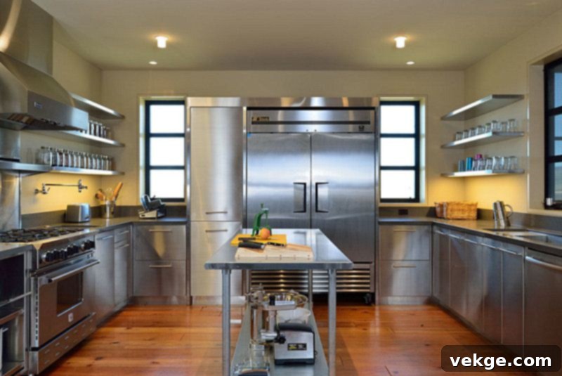 Industrial kitchen featuring a large stainless steel refrigerator, evoking factory vibes