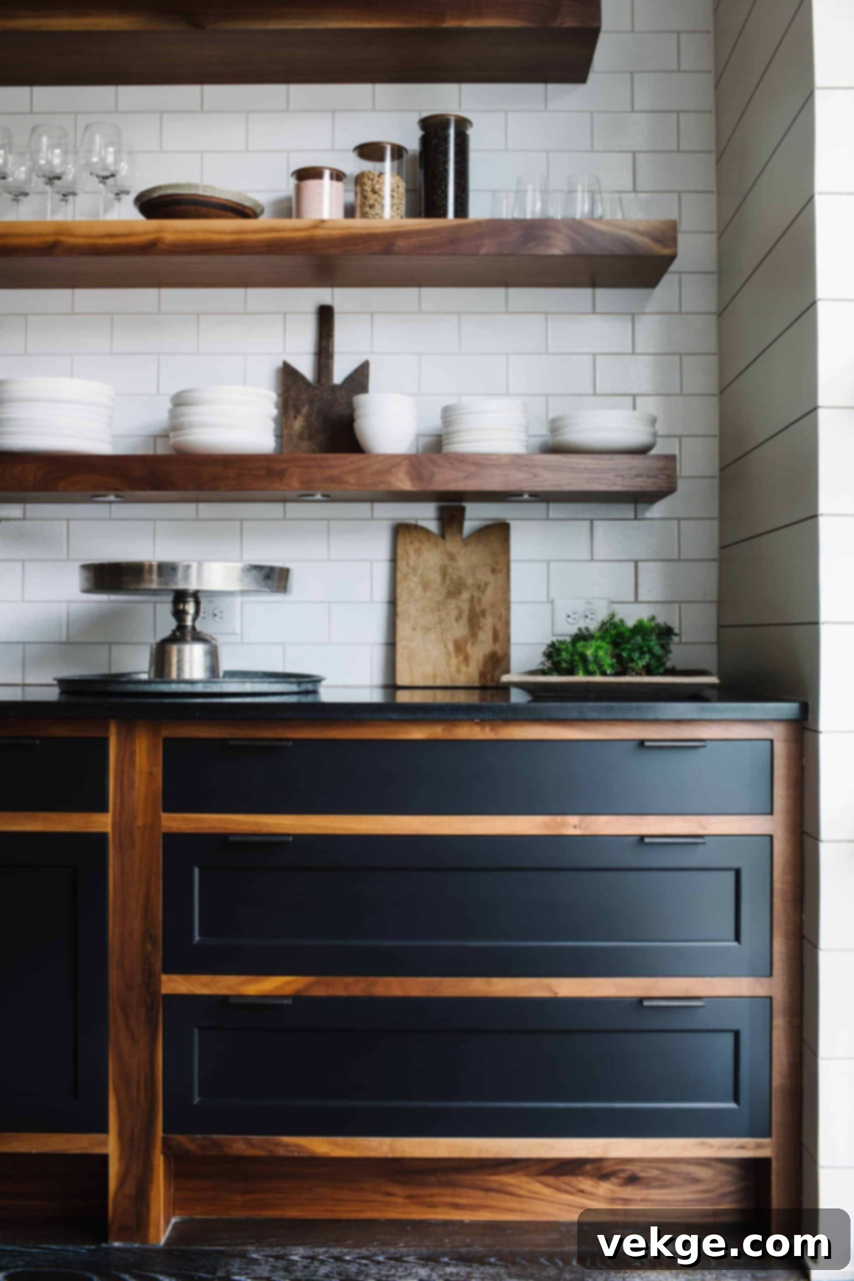 Wooden shelves contrasting with stark black cabinets in an industrial kitchen