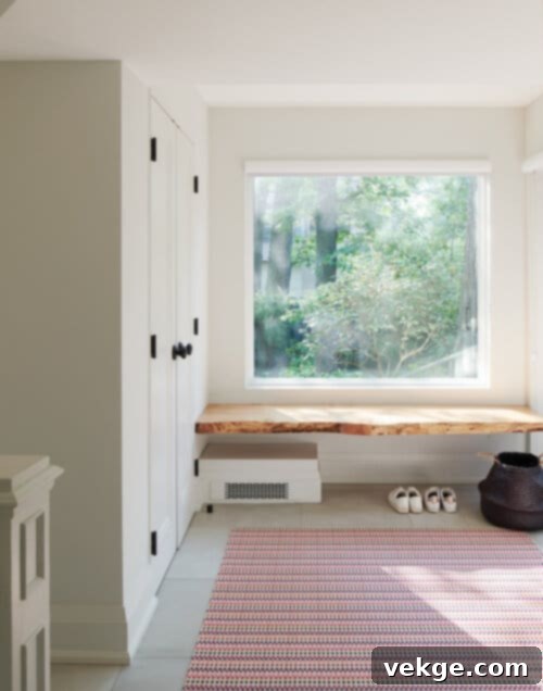 rustic live edge floating bench beneath a window in a mudroom