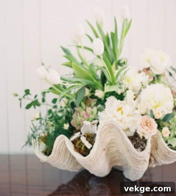 Flower arrangement for nautical coastal bedroom ideas, featuring blue hydrangeas and seashells