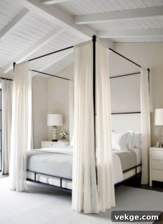 Bedroom with a tall four-poster bed, creating an illusion of high ceilings in a coastal setting