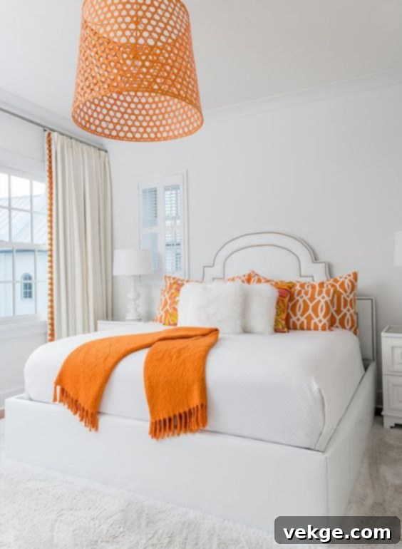 Bedroom with neutral tones and a vibrant pop of color from a throw pillow and artwork