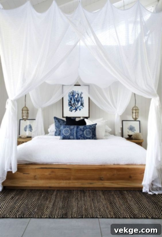 Elegant neutral canopy bed in a coastal-themed bedroom, serving as a sophisticated focal point