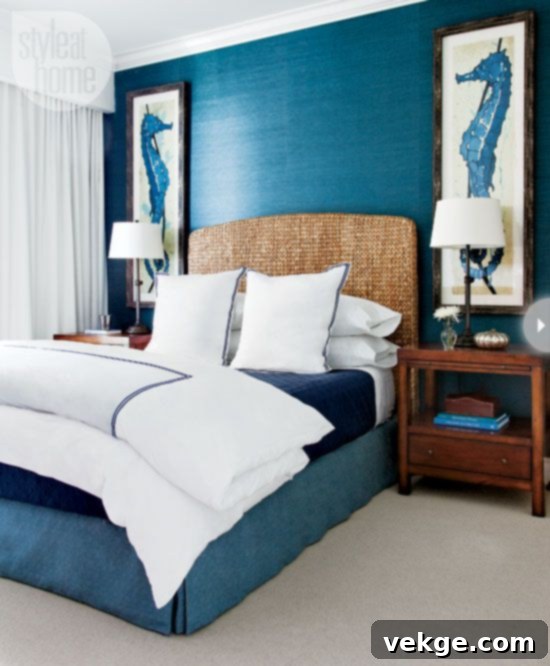 Bedroom with a striking navy blue accent wall, creating a deep coastal atmosphere