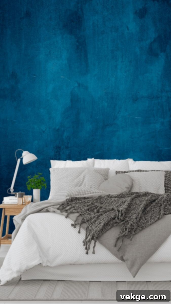 Bedroom with a bold blue accent wall, evoking a deep ocean feel