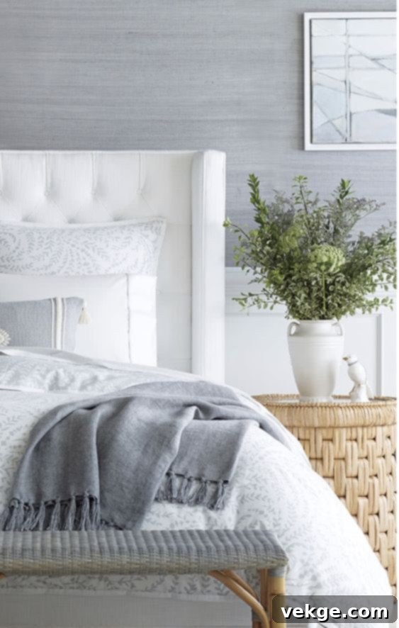 Bedroom with natural textured wallpaper, adding subtle coastal elegance