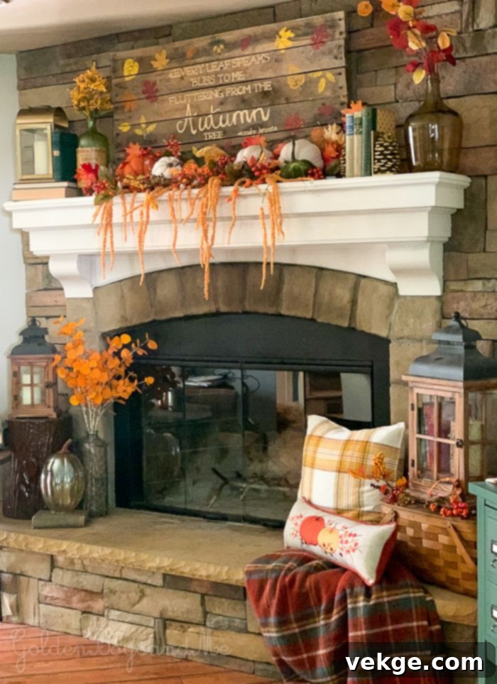Farmhouse fireplace with pumpkins, candles, and a rustic wooden ladder