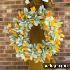 Faux fall wreath with autumn leaves and berries