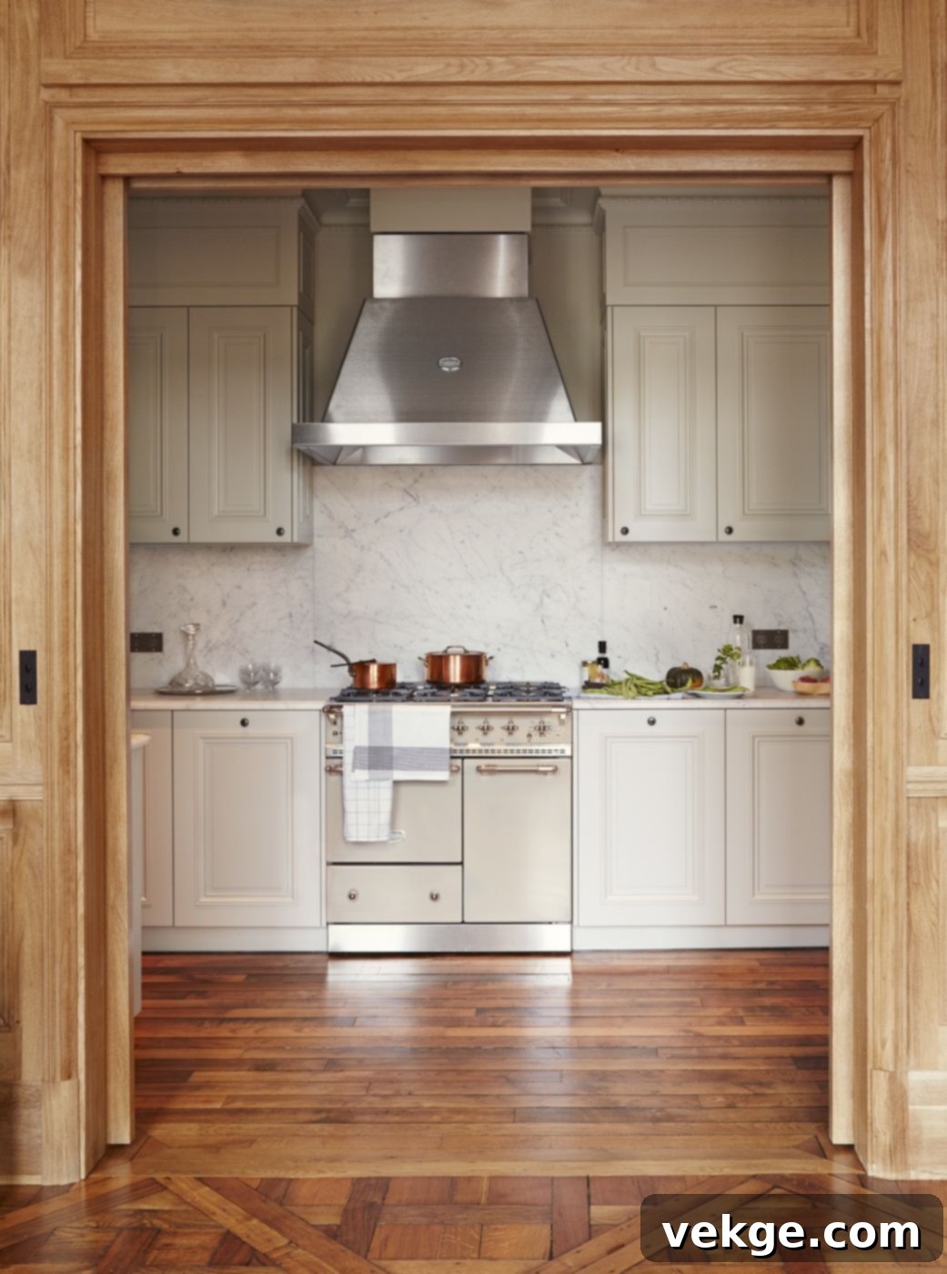 A luxurious black Lacanche range cooker with brass accents, integrated into a sleek, modern Parisian kitchen.