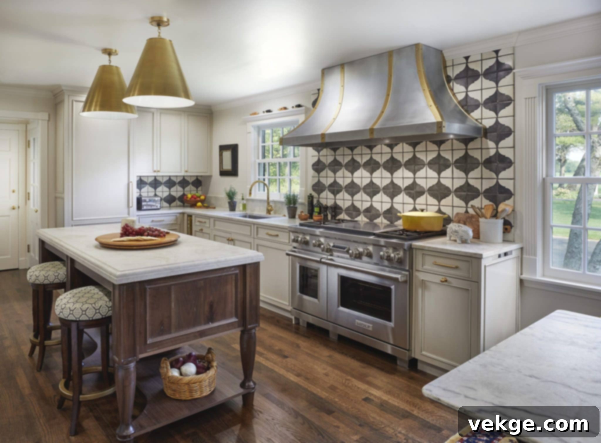 A chic Parisian kitchen featuring light-colored cabinetry, a large window, and a stylish patterned wallpaper on the accent wall.