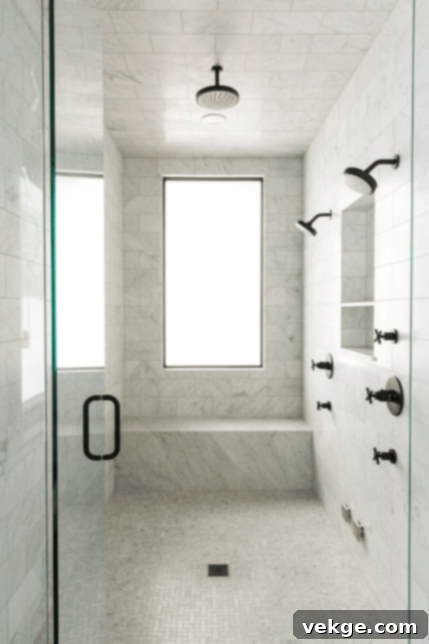 marble bathroom with dark fixtures