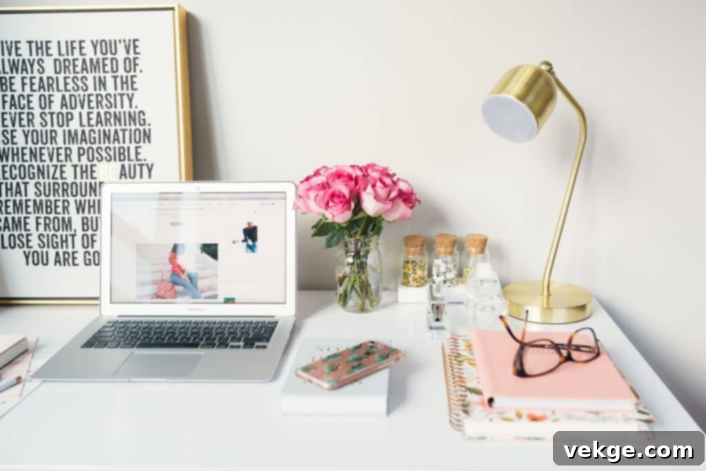A beautifully organized, minimalist student study space in a small apartment with a wooden desk, potted plant, laptop, and natural light from a window.