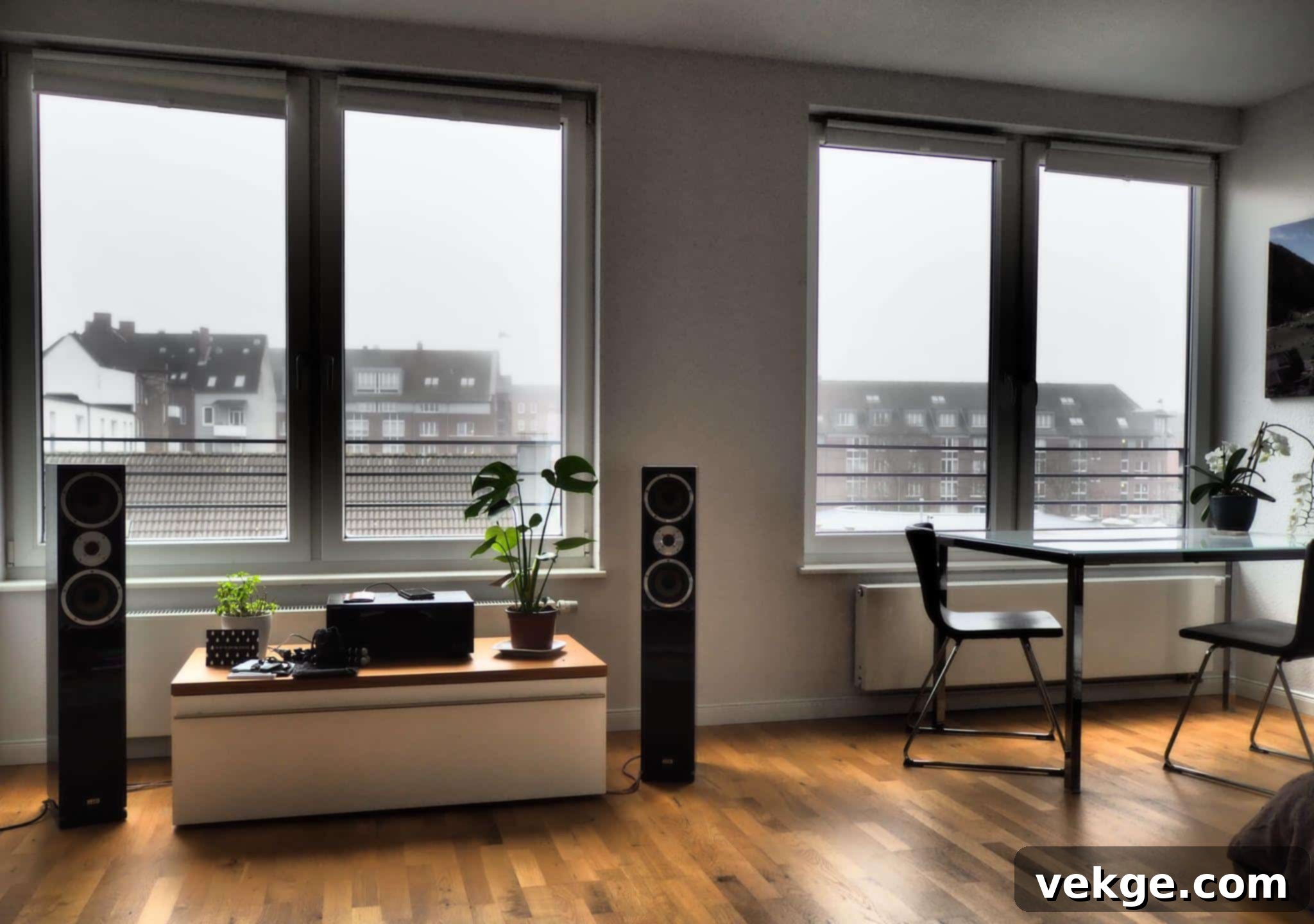 A sleek home theater setup with a large screen and multiple speakers, illustrating a modern sound system.