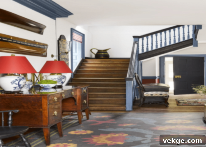 Staircase with vintage-inspired wrought iron railings and classic decor, showcasing how antique elements can be a modern trend